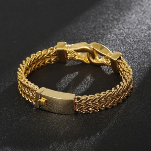 Detailed macro shot of chunky double-row gold dragon bone chain bracelet with metal clasp