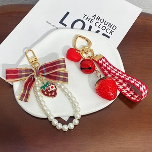 Cute strawberry keychain with red bow and heart bell charm for stylish handbags