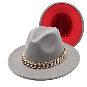 Detail of grey and red two-tone fedora hat with chunky gold acrylic chain decoration