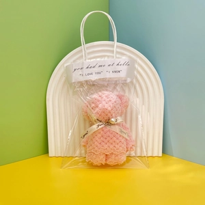 Pink coral fleece bear-shaped towel gift in a clear PVC bag with decorative ribbon