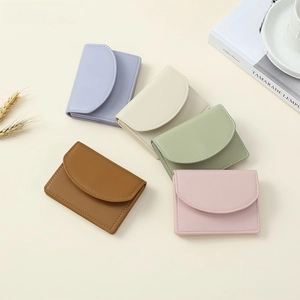 Detail of five macaron-colored vintage envelope wallets with matte leather and fine stitching