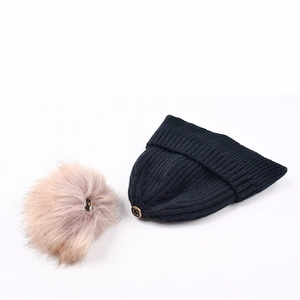 Black ribbed knit winter beanie with detachable pink-brown faux fur pom-pom ball