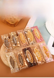 Detail of assorted nut tart cookies in elegant patterned heat-sealed gift packaging