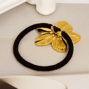 Close-up of black elastic hair tie featuring a polished gold 304 stainless steel flower