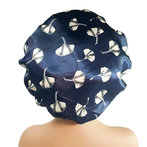 Rear view of extra-large satin sleep cap with white ginkgo leaf print on navy blue