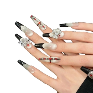 Long black cat eye press-on nails with 3D rhinestone bows and ruby cross charms