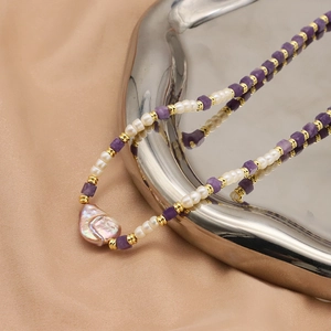 Baroque pearl and purple amethyst beaded necklace on elegant silk and silver tray