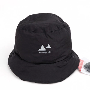 Detail of black quilted puffy bucket hat featuring a white mountain logo and warm lining