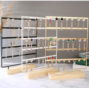 Detail of multi-tier metal earring display stand with solid wood base in three colors
