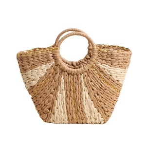 Large beige woven straw tote bag with gold thread accents and round top handles