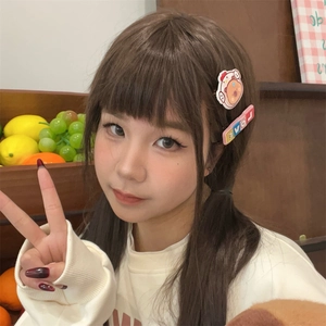 Close-up of cute cartoon astronaut and LOVE letter hair clips on a female model