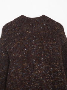 Detail shot of brown marl knit sweater showing textured multicolored yarn fabric