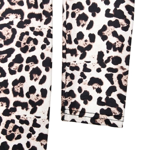 Close-up of leopard print fabric showing high-quality double stitching on the sleeve cuff