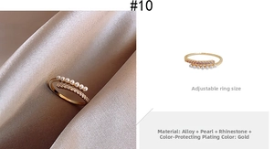 Detail of adjustable gold ring with small white pearls and sparkling rhinestones