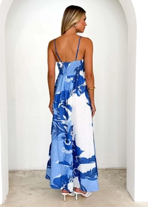 Detail of blue floral maxi dress featuring backless design and ruched elastic waist