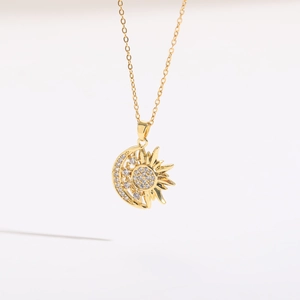 Detailed view of the 14K gold-plated sun and moon pendant with shimmering white zircons