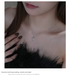 Detail of s925 silver Mobius pendant necklace with multi-layer plating on model