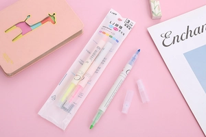 Detailed macro view of dual-tip highlighter markers set in light yellow and pink colors