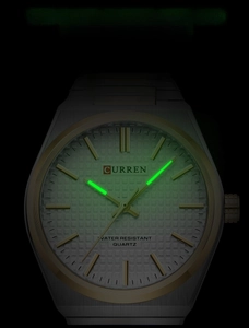 Close-up of Curren quartz watch dial showing luminous hands and markers in dark conditions