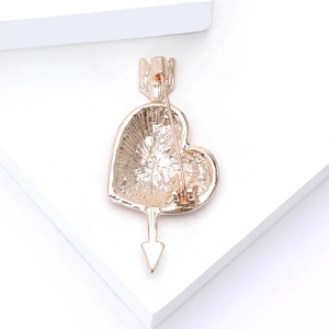 Detailed back view of a rose gold heart and arrow brooch showing its textured finish and pin