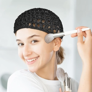 Detailed macro view of the black hand-crocheted hair net with mesh texture and bow detail