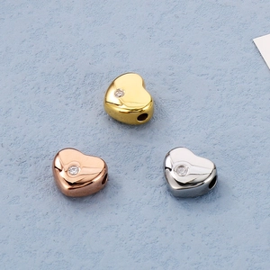 Vue détaillée de perles en forme de cœur en or, or rose et argent avec zircone cubique