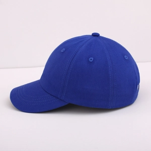 Detail view of deep blue cotton twill baseball cap with six-panel crown and curved brim
