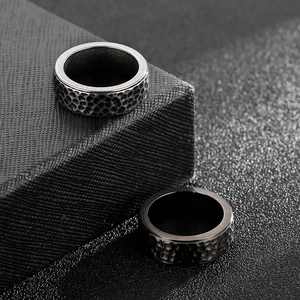 Detail view of silver and black hammered texture titanium steel rings for men