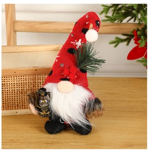 Detail of Christmas gnome holding a vintage lamp with knitted hat and long white beard