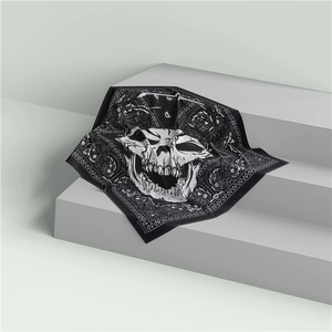 Cotton paisley bandana with white skull print displayed on a modern grey podium stand