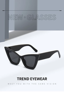 Detail of trendy black cat-eye sunglasses with wide temples and grey lenses