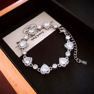 Detail of S925 silver heart bracelet with white zircon stones on black jewelry box