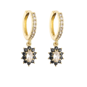 Detail of gold hoop earrings with white oval gemstone and black flower petals