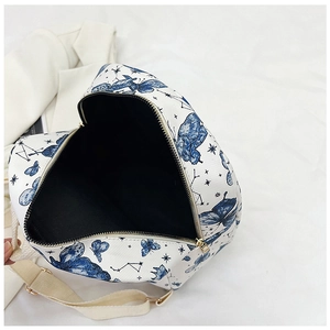 Detailed interior view of butterfly print backpack showing black lining and gold zipper