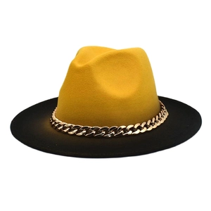 Close-up of contrast yellow and black wool fedora featuring a stylish gold metal chain