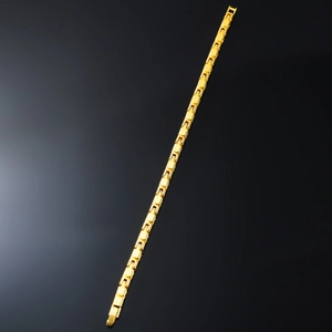 Macro view of gold interlocking rectangular links on a luxury chain bracelet