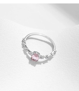 Detail shot of s925 silver ring featuring oval pink crystal and sparkling accent stones