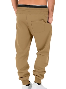 Detail of khaki men's joggers showing elastic waistband and ribbed ankle cuffs back view