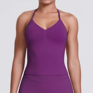 Detail of seamless purple workout top with V-neck pleats and ribbed elastic fabric texture