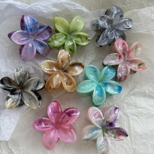 Nine-piece set of marble floral hair claws in vibrant colors on a white background