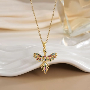 Detailed close-up of a gold phoenix pendant with colorful zircon micro-inlay on a fine chain