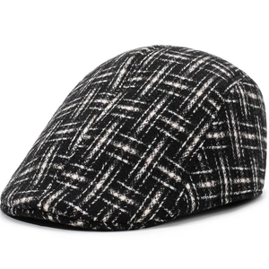 Macro detail of high-quality black and white tweed fabric on an classic men's flat cap