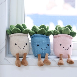 Three plush succulent plant pots with legs sitting on a window sill in soft natural light