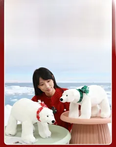 Detail of Christmas polar bear plushies wearing festive red and green patterned scarves
