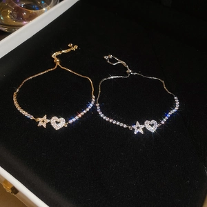 Detailed view of adjustable star and heart bracelets with sparkling cubic zirconia