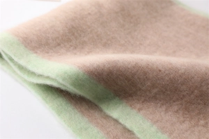Detail view of the soft faux cashmere material and contrast green edge stitching