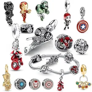 Macro view of Marvel superhero charms featuring Spider-Man and Iron Man on silver bracelet