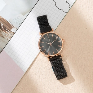 Detail view of women's rose gold quartz watch with black magnetic strap and crystal dial