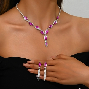 Close-up of bridal jewelry set with magenta marquise stones and teardrop fringe details