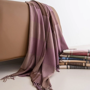 Checkered cashmere-feel scarf with tassels in pink and purple on leather seat